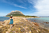 A girl is walking in the Spalmatore Cape on the Island of Tavolara (Olbia, Sassari province, Sardinia, Italy, Europe) (MR)