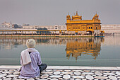 pilgrim and sacred pool Amrit Sarovar, Golden temple, Amritsar, Punjab, India