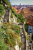 above; aerial; aerial view; architecture; attraction; austria; balcony; beautiful; bell; belltower; blue; brick; building; castle; city; cityscape; clear; clock; clocks; clocktower; day; daylight; daytime; destination; downtown; europe; european; exterior; exteriors; famous; fortification; fortress; graz; green; heritage; hill; historic; historical; house; landmark; main; medieval; monument; mountain; old; outdoor; outdoors; overview; panorama; panoramic; park; people; platz; red; roof; roofs; rooftops; schlossberg; sightseeing; sky; skyline; square; streetcar; styria; summer; sunny; symbol; t