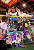 Lucha Libre. Julieta and Celia la Simpatica during a crazy combat, agaist males wrestlers, Sports center La Ceja, El Alto, La Paz, Bolivia