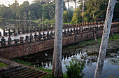 Biking, bridge and moat of South Gate, in Angkor Thom, Siem Reap, Cambodia
