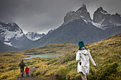 Family walking near Mirador Cuernos, You can see the amazing Cuernos Del Paine, Torres del Paine national park, Patagonia, Chile