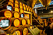 Guinness story on the TV- barrels, at Guinness Storehouse, museum, brewery, exhibition, Dublin, Ireland