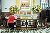 Betende Frau mit Mobiltelefon, in der Basilika Unserer Lieben Frau von Candelaria, Medellín, Kolumbien