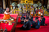 Monk blessing women, in Wat Arun (Temple of Dawn), also called Wat Bangmakok Noek, Bangkok, Thailand