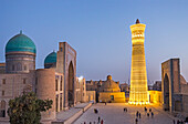 At right Kalon minaret and mosque. At left Mir-i-Arab medressa , Bukhara, Uzbekistan