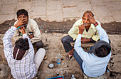 Morning shave, street scene in Assi Ghat, Ganges river, Varanasi, Uttar Pradesh, India.