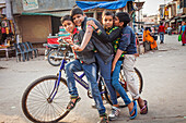 Friends riding a bike, in Raman Reti Road, Historical Center,Vrindavan, Mathura, Uttar Pradesh, India