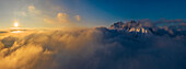 Aerial view of Presolana mountain at sunset over the clouds, Castione della Presolana, Bergamo, Lombardy, Italy, Southern Europe