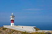 Woman at Cabo Ortegal and its lighthouse at sunrise, Cariño, Coruña, Galicia, Spain, Iberina Peninsula, Western Europe