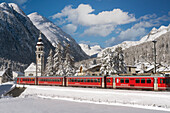 Bernina Express stops at the village of Bever, Graubunden, Engadine, Switzerland