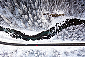 Aerial view of cars traveling on a mountain road in winter, Graubunden, Engadine, Switzerland