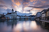 View of the Jesuit Church and the old town of Lucerne at sunset reflected on the Reuss river. Lucerne, canton of Lucerne, Switzerland.
