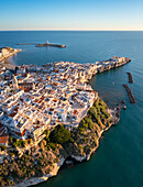 Aerial view of Vieste old town peninsula during a summer sunrise. Foggia province, Gargano National Park, Apulia, Italy.