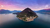 Aerial view of Monte Isola and Peschiera Maraglio village at sunset on Iseo lake. Peschiera Maraglio, Montisola, Brescia province, Lombardy district, Italy, Europe.