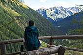 A young girl is admiring the landscape from the panoramic point near the Saent waterfalls, Piazzola, Rabbi, Rabbi Ralley, Autonomous Province of Trento, Trentino Alto-Adige/sudtirol, Italy