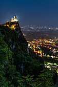 Europe, Italy, San Marino: night view of the castle above the city