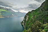 Coast of the mountain in foreground, around Sperone of Ponale in Ponale path, with mountains and lake of garda in background Riva del Garda, Trentino alto adige, Italy, north Italy, south Europe, province of Trento.