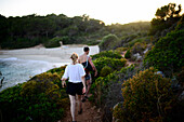 Eine Gruppe von Freunden wandert auf einem Küstenpfad in der Nähe von Cala Varques auf Mallorca, Spanien