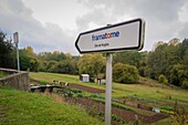 Direction sign for the framatome factory in front of the allotment garden in the company town of moulin a papier (paper mill), rugles, eure, normandy, france