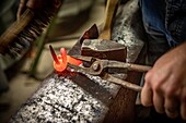 Steel coming out of the forge for fashioning, the art of working the iron, nicolas martin, skilled metalworker, beaumais forge, gouville, mesnil-sur-iton, eure, normandy, france