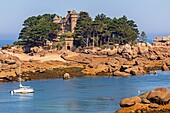 Sailboat moored in front of the chateau de costaeres, tregastel, chemin des douaniers coastal path of ploumanac'h, cote de granit rose (pink granite coast), cotes-d'amor, brittany, france