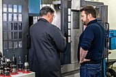 The ceo guilhem morel with a salaried worker in front of his digital tower, manufacture of metal cutters for cutting tools, pelletier et jaminet company, l'aigle, orne, normandy, france