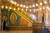 Guardian in front of the minbar of sculpted and gilded cedar inside the alabaster mosque of muhammad ali, 19th century turkish style, saladin citadel, cairo, egypt, africa