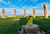 Man taking picture with the smartphone at sunset at the site of Dodekalitten, Lolland island, Zealand, Denmark, Europe