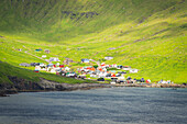 View of the colourful village of Funningur at sunset, Eysturoy island, Faroe islands, Denmark, Europe