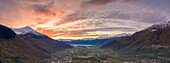 Aerial view of lower Valtellina and Alto Lario under the burning sky at sunset, Sondrio province, Lombardy, Italy
