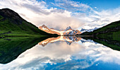 Peaks mirrored in the pristine water of Bachalpsee lake at sunset, Grindelwald, Bernese Oberland, Bern Canton, Switzerland
