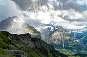 Wetterhorn and Schreckhorn peaks lit by rainbow in the storm clouds, First, Grindelwald, Bernese Alps, Canton of Bern, Switzerland