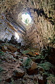 Light beam filters along the vertical tunnel inside Castellana Caves (Grotte di Castellana), Bari province, Apulia, Italy