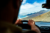 Personal perspective of man driving to Cofete Beach, Jandia natural park, Fuerteventura, Canary Islands, Spain