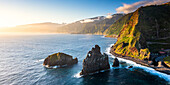 Aerial panoramic of Ilheus da Rib and Ribeira da Janela rock formations at dawn, Atlantic Ocean, Madeira island, Portugal