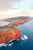 Red rocks of cliffs at dawn, aerial view, Ponta Do Rosto viewpoint, Sao Lourenco Peninsula, Madeira island, Portugal