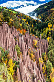 Rock spires of the earth pyramids emerging in the autumn woods, Longomoso, Renon/Ritten, Bolzano, South Tyrol, Italy