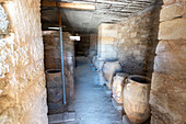 Ancient clay amphoras in the storage room of the Minoan palace of Phaistos, Southern Crete, Greece