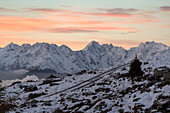 Romantic pink sky at dawn over Alpe Rogneda and Pizzo di Coca mountain peak covered with snow, Rhaetian Alps, Lombardy, Italy