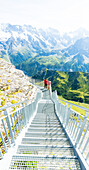 People admiring mountains from the Thrill Walk steel walkway, Murren Birg, Jungfrau Region, Bern canton, Switzerland