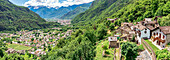 Aerial panoramic of the alpine village of Crana and Chiavenna town in summer, Piuro, Valchiavenna, Valtellina, Lombardy, Italy