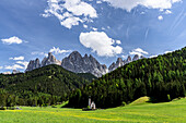 The iconic church of San Giovanni (St. John) in Ranui with majestic Odle peaks in background, Funes Valley, South Tyrol, Italy