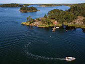 Aerial view of typical houses and small dock in Korpo or Korppoo island, Korpostrom coast Southwest Finland Turku archipelago. The archipelago ring road or Saariston rengastie is full of things to see, do and do. The Archipelago Trail can be taken clockwise or counter clockwise, starting in the historical city of Turku, and continuing through rural archipelago villages and astonishing Baltic Sea sceneries. The Trail can be taken from the beginning of June until the end of August.