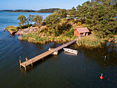 Aerial view of typical houses and small dock in Korpo or Korppoo island, Korpostrom coast Southwest Finland Turku archipelago. The archipelago ring road or Saariston rengastie is full of things to see, do and do. The Archipelago Trail can be taken clockwise or counter clockwise, starting in the historical city of Turku, and continuing through rural archipelago villages and astonishing Baltic Sea sceneries. The Trail can be taken from the beginning of June until the end of August.