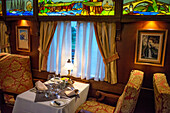 Interior of restaurant car railway carriage of Transcantabrico Gran Lujo luxury train travellong across northern Spain, Europe. First Class dining area railway coach.