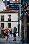 Pilgrims in Rua de San Pedro street in the old Town, Santiago de Compostela, UNESCO World Heritage Site, Galicia, Spain.