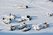 Small boats in the frozen harbor. Ilulissat, Greenland.