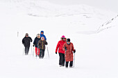 Locals walking on a trail to Ilulissat Icefjord, an UNESCO World Heritage Site. Ilulissat, Greenland.