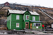 A bright green house in the Russian settlement of Barentsburg. Barentsburg, Spitsbergenn Island, Svalbard, Norway.